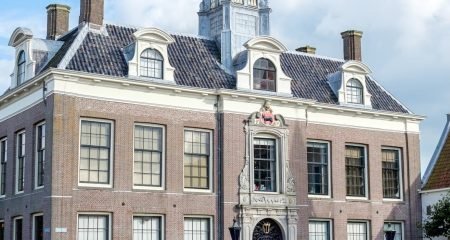 People waiting with documents in a bright Dutch city hall